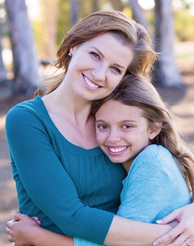 Mom and daughter smiling